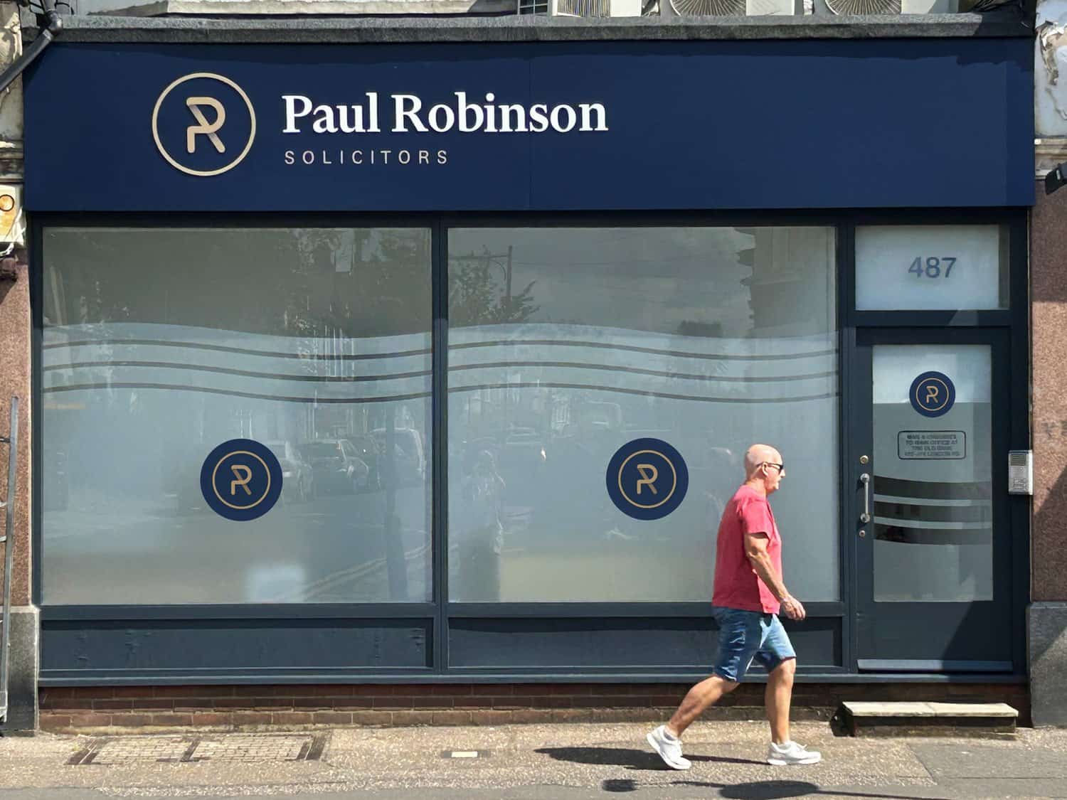 Paul Robinson Solicitors storefront with logo and window display in the UK.