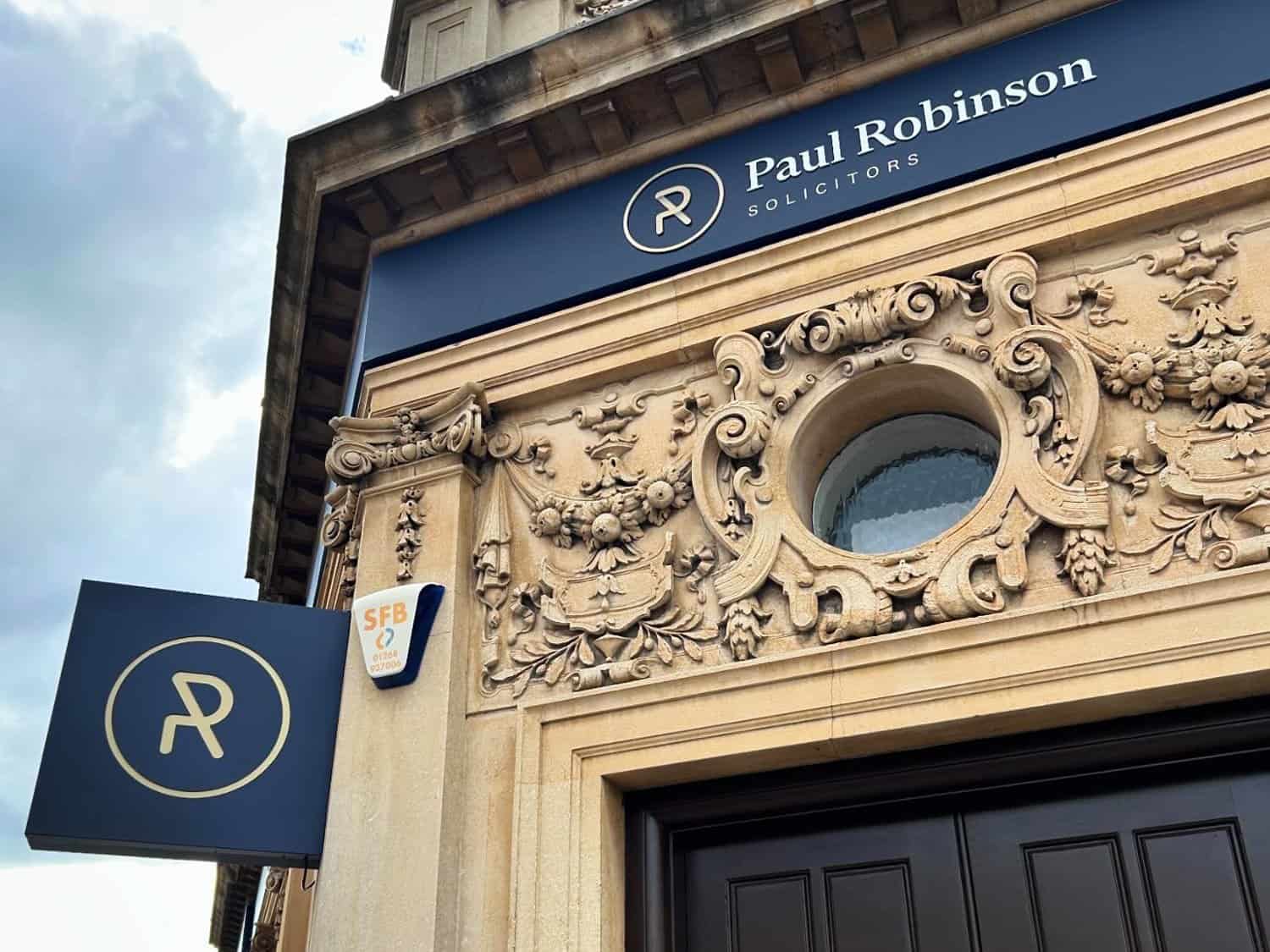 Professional law firm office exterior with Paul Robinson Solicitors signage and ornate architectural.