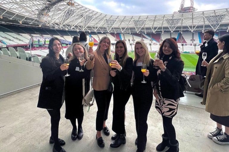 Enjoying drinks at a stadium event with friends before a match.