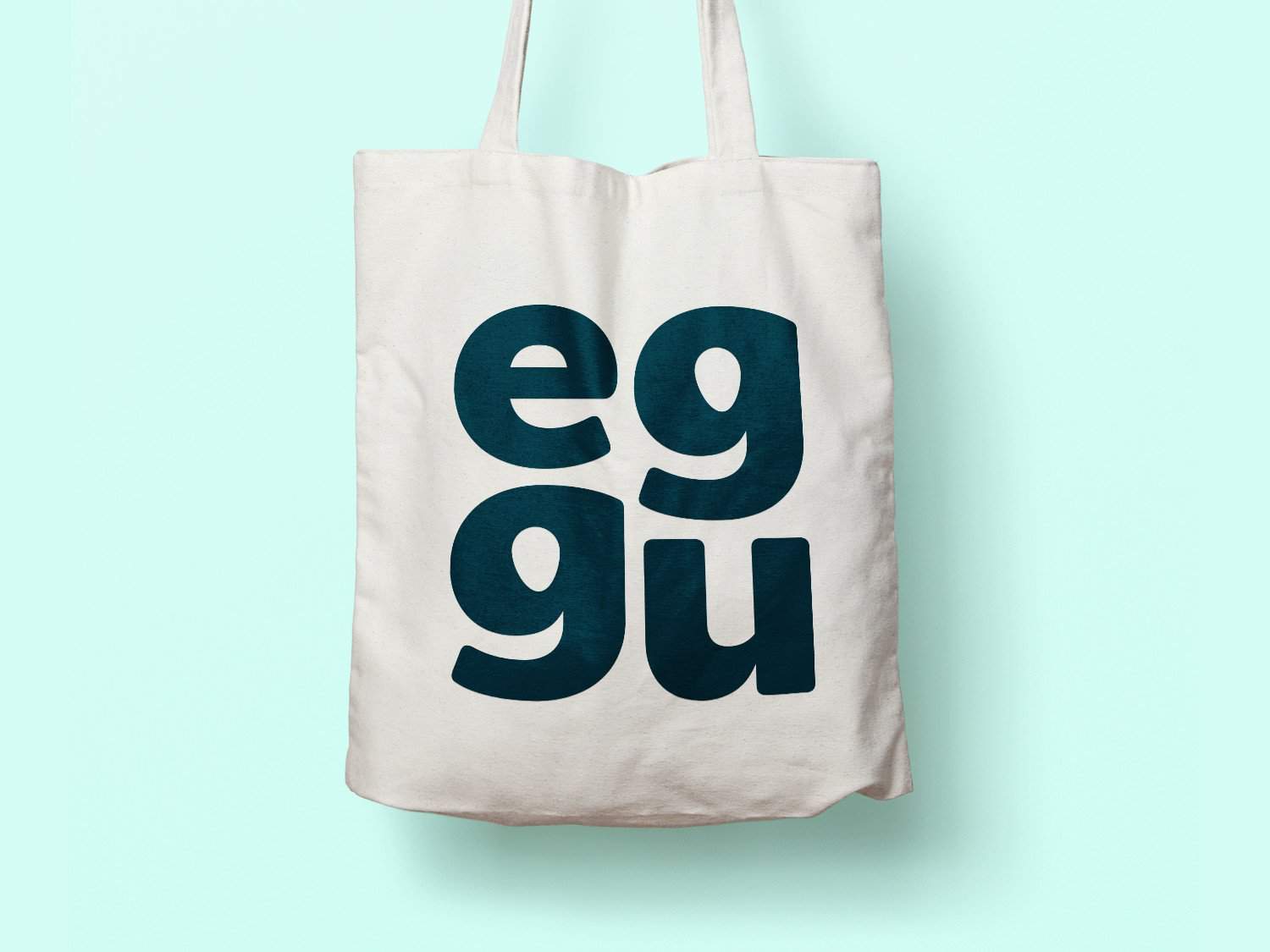 Eggu tote bag with bold black text on white fabric, eco-friendly shopping accessory.