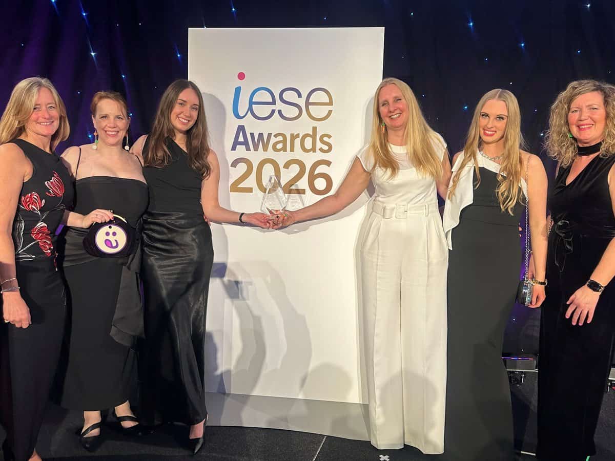 Celebrating success at the IESE Awards 2026 with a diverse group of women in formal attire.